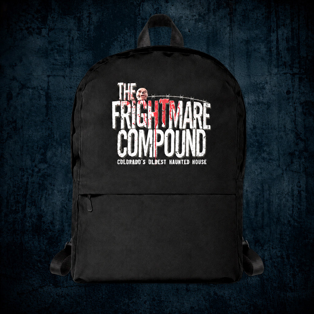 A black backpack featuring a distressed white and red graphic print that reads 'THE FRIGHTMARE COMPOUND' with 'COLORADO'S OLDEST HAUNTED HOUSE' underneath, shown against a dark textured blue background.