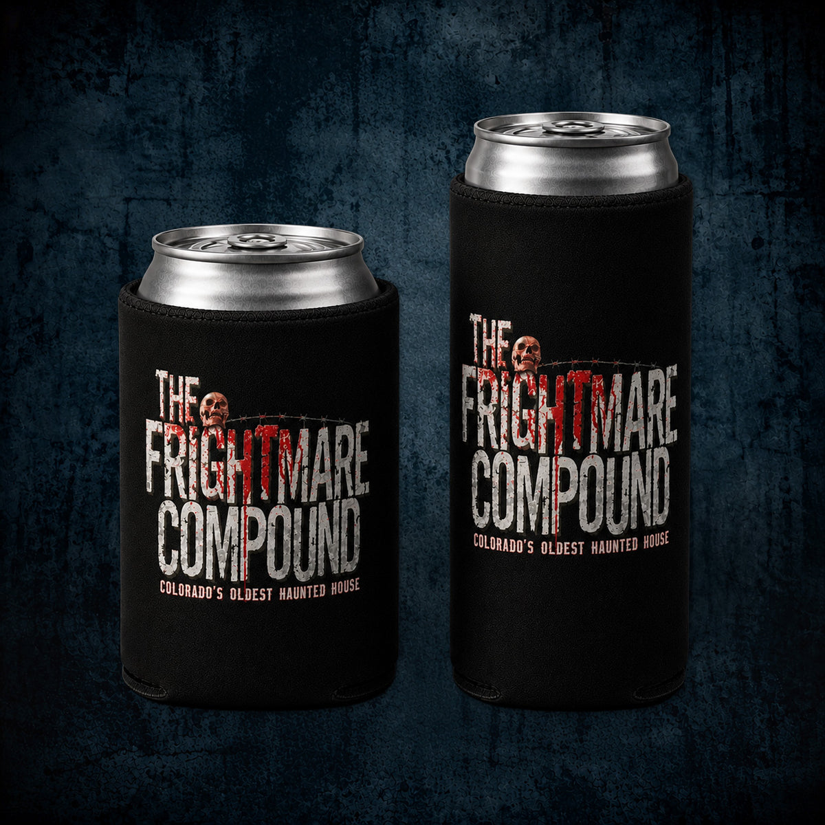 Two black can coolers holding aluminum cans, displayed against a dark textured background. The coolers feature a graphic design for 'The Frightmare Compound' with white and red lettering.