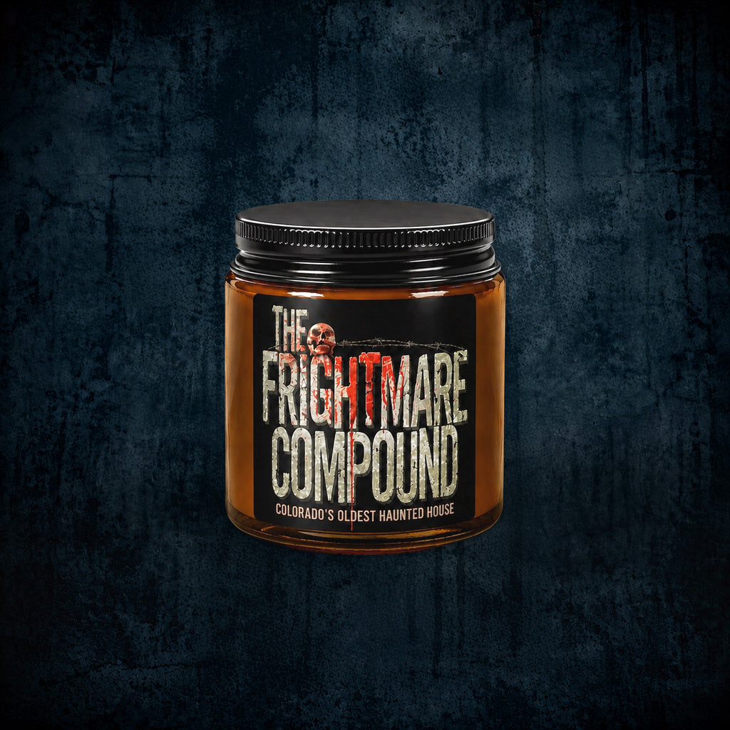 A jar of 'The Frightmare Compound' by Colorado's Oldest Haunted House, featuring an amber glass container, a black lid, and a black label with white and red text, set against a dark textured background.