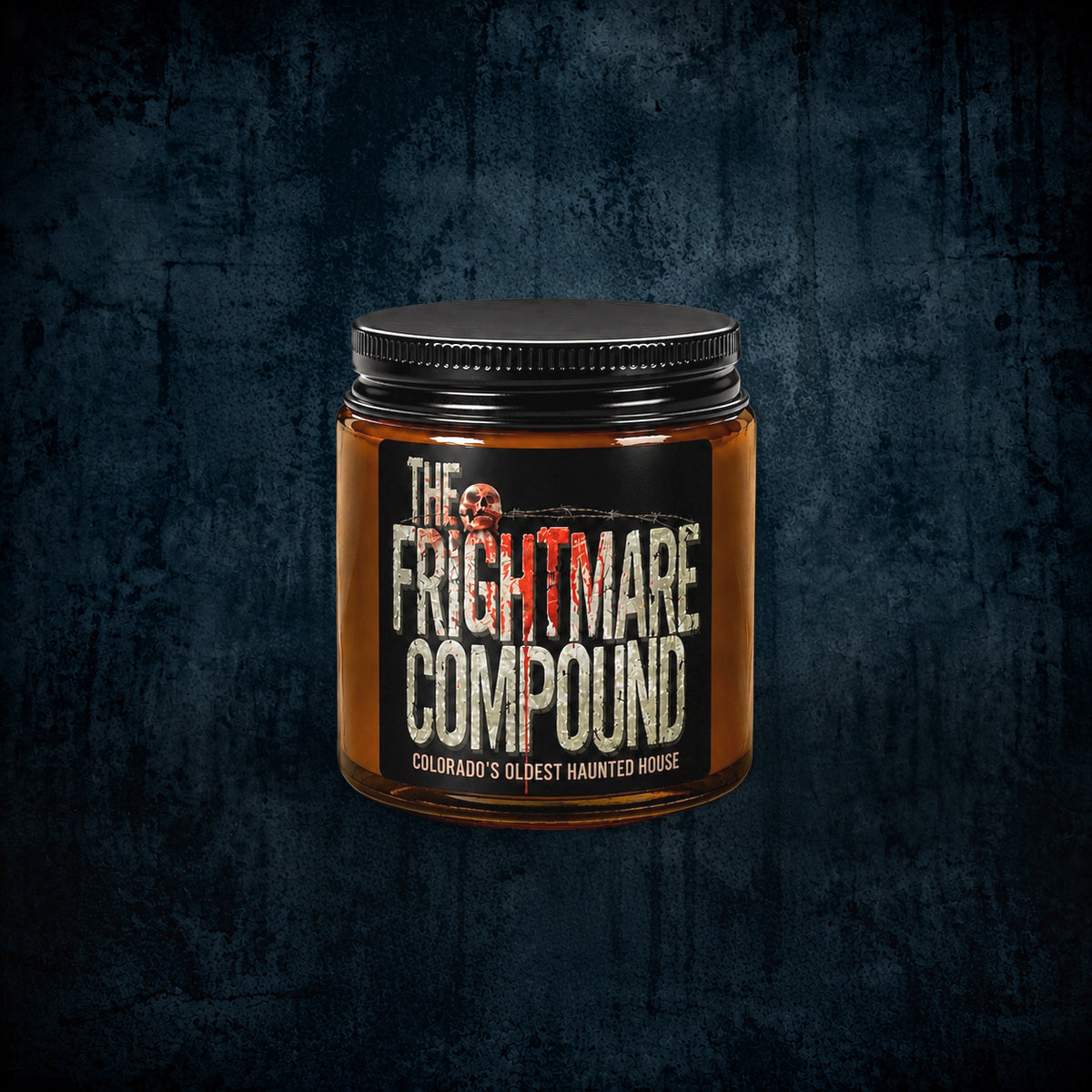 A jar of 'The Frightmare Compound' by Colorado's Oldest Haunted House, featuring an amber glass container, a black lid, and a black label with white and red text, set against a dark textured background.
