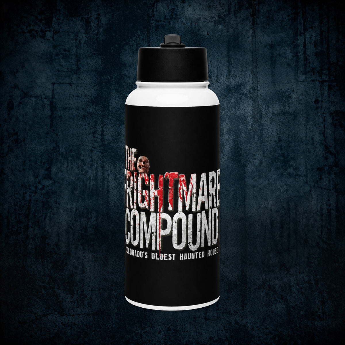 A white and black insulated water bottle with a black lid, featuring a spooky graphic that reads 'The Nightmare Compound' and 'Colorado's Oldest Haunted House' on a dark textured background.