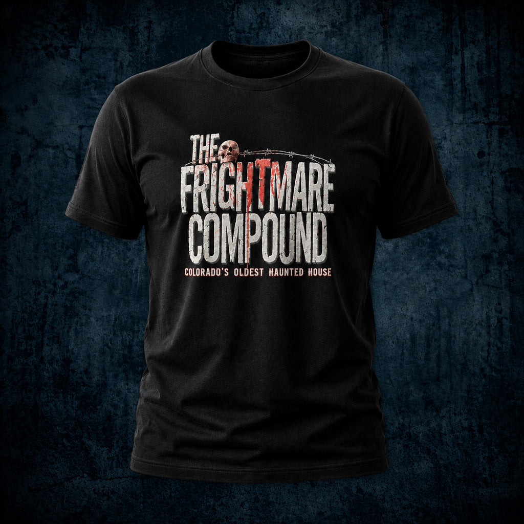 A black short-sleeve graphic t-shirt featuring the text 'THE FRIGHTMARE COMPOUND' in distressed white and red lettering, with a skull graphic and the subtitle 'COLORADO'S OLDEST HAUNTED HOUSE', displayed against a dark textured blue background.