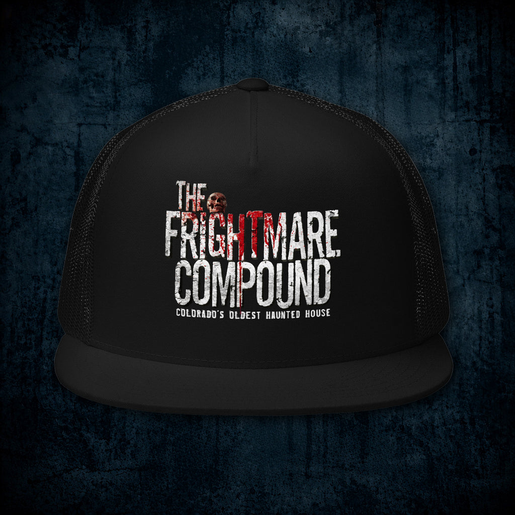 A black trucker hat with a distressed white and red graphic reading 'The Frightmare Compound' and 'Colorado's Oldest Haunted House' on the front panel, shown against a dark textured blue background.