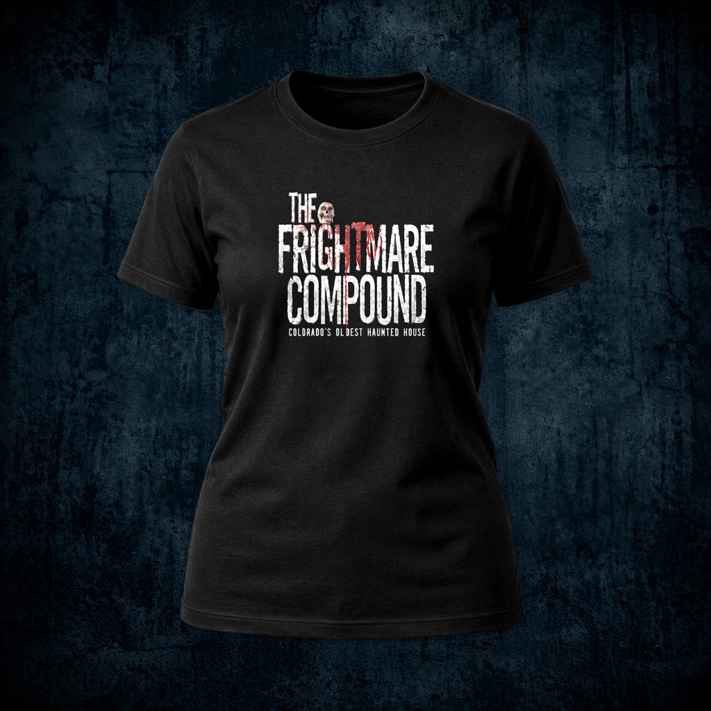 A black short-sleeve crewneck t-shirt featuring a distressed white and red graphic print that reads 'THE FRIGHTMARE COMPOUND' with 'COLORADO'S BEST HAUNTED HOUSE' underneath, displayed against a dark textured blue background.