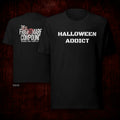 Two black graphic T-shirts shown against a dark red textured background, with the front shirt displaying 'HALLOWEEN ADDICT' in white text and the back shirt displaying 'THE FRIGHTMARK COMPOUND' in white and red text.